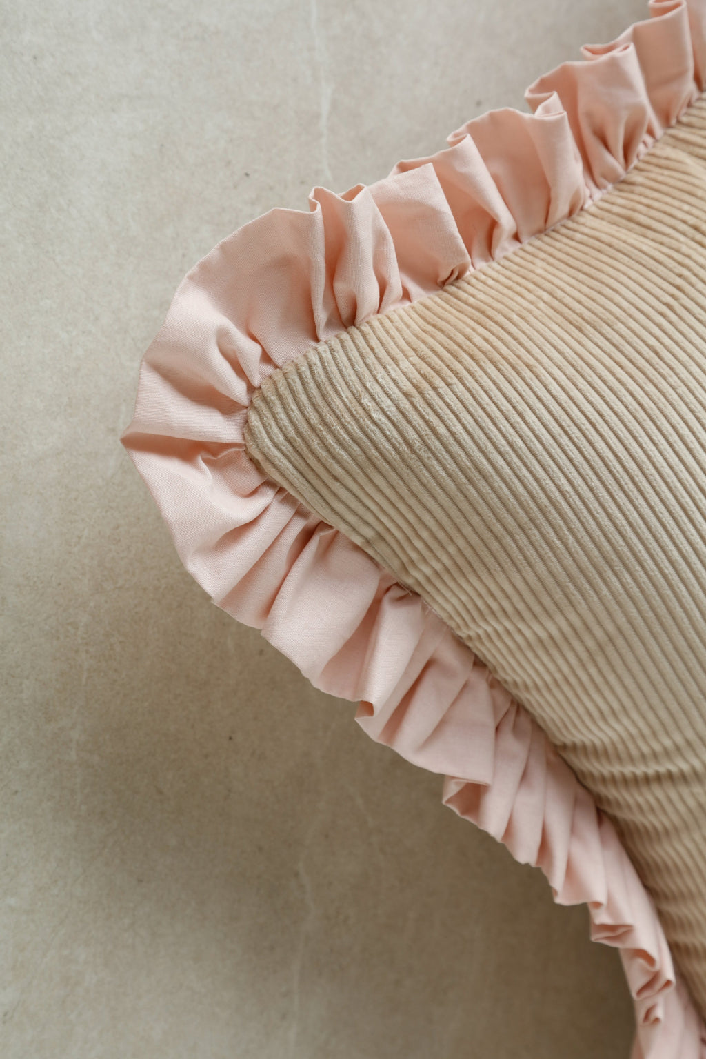 Close-up of Kind Words Rosewater Cushion fabric showing velvet pile and stitching details.