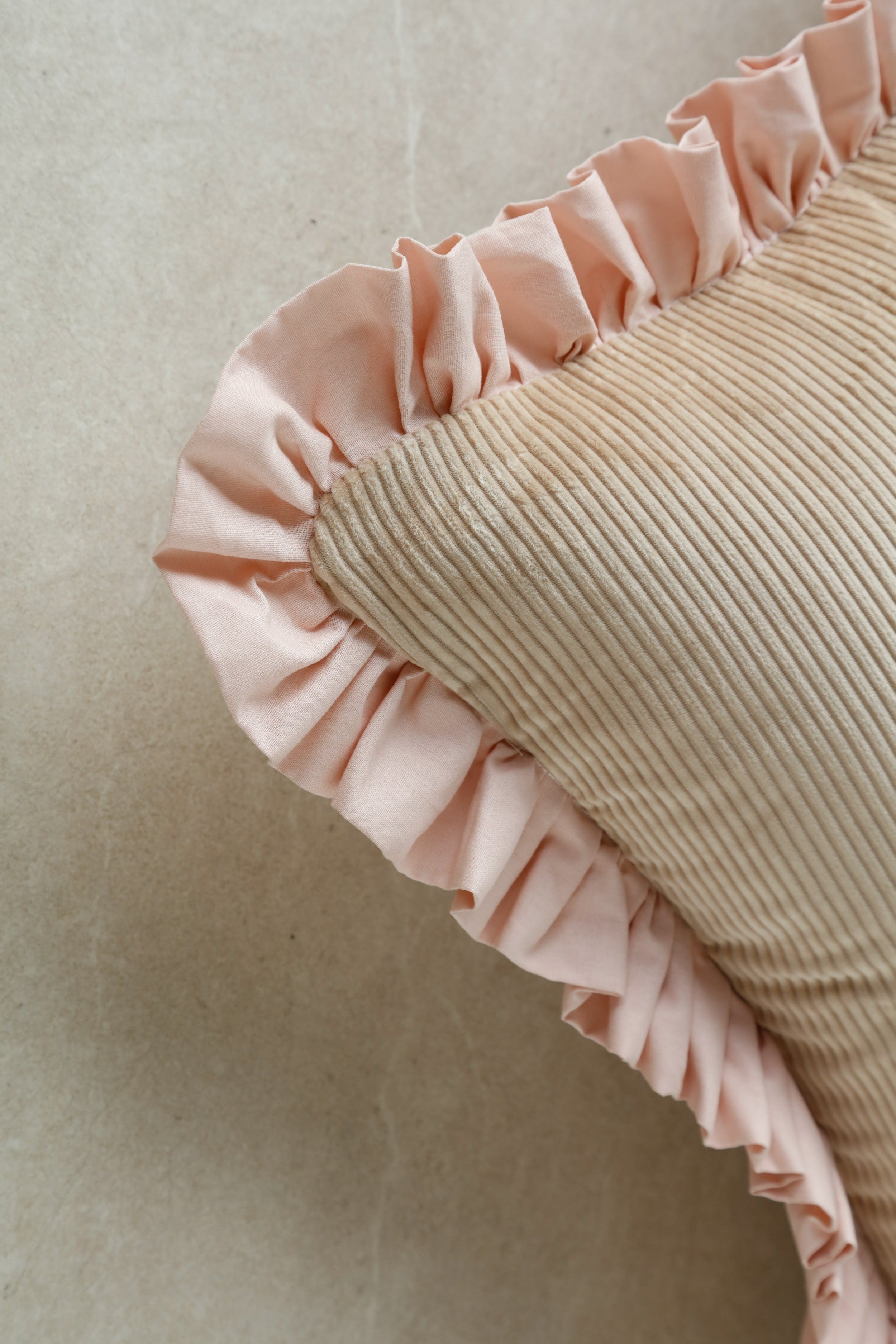 Close-up of Kind Words Rosewater Cushion fabric showing velvet pile and stitching details.