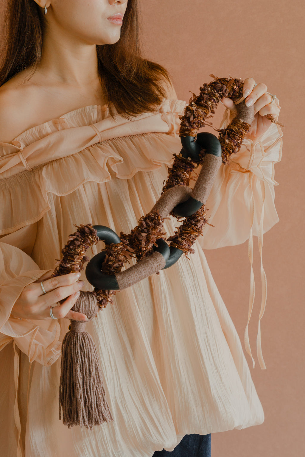 Handmade ‘Passing By Blooms Mocha’: layered threads in caramel hues and cream, with leather textures reminiscent of blossoming petals.