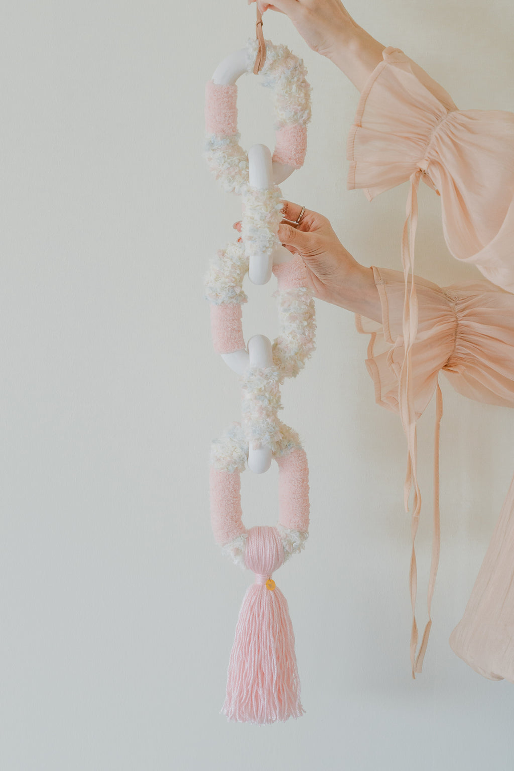Handmade ‘Passing By Blooms Rose’: romantic pink and ivory threads intertwine, creating a blooming, textured tapestry.