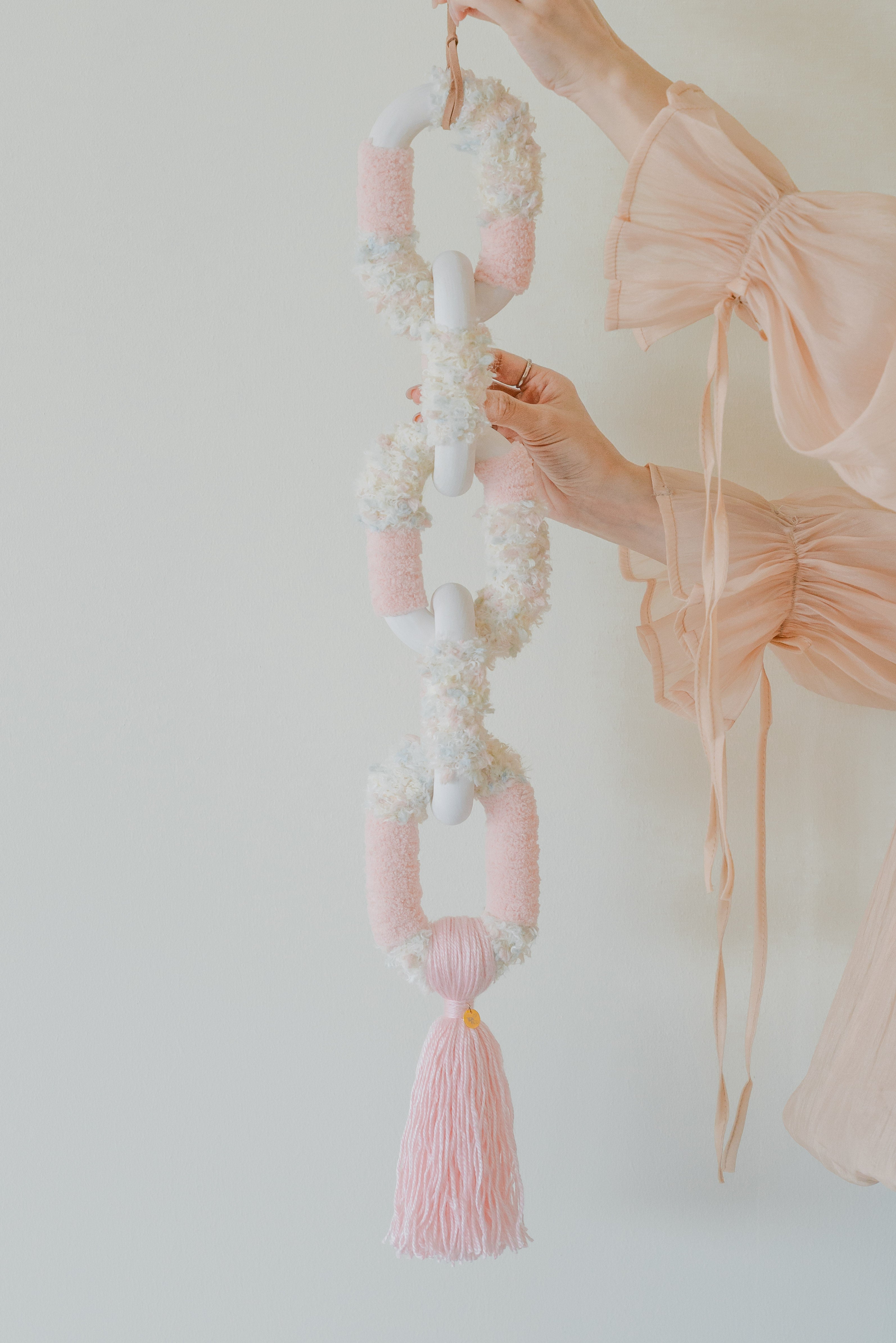 Handmade ‘Passing By Blooms Rose’: romantic pink and ivory threads intertwine, creating a blooming, textured tapestry.