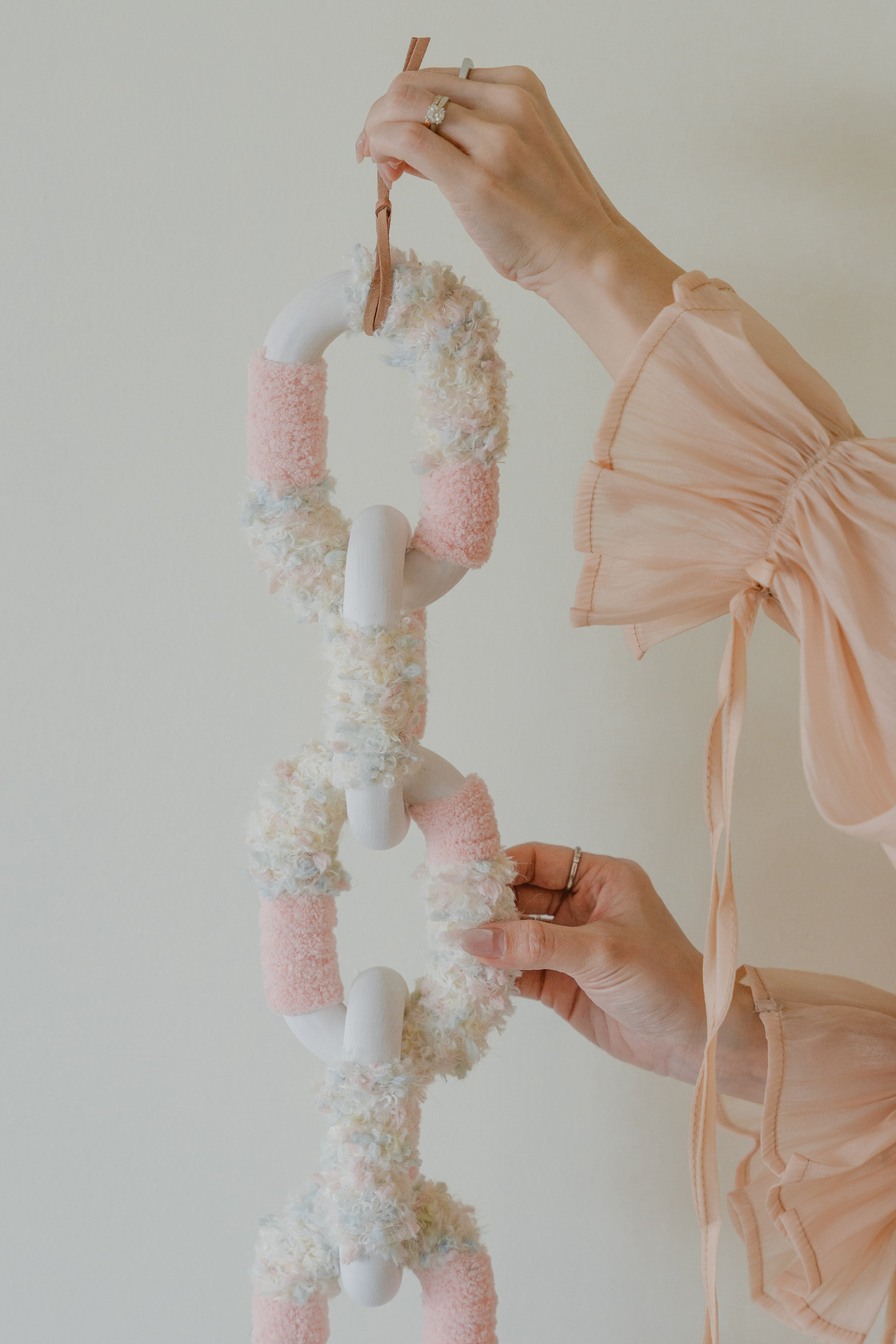 Bespoke fibre tapestry ‘Passing By Blooms Rose’: dusty rose yarn and leather trimming evoke the softness of garden blossoms.