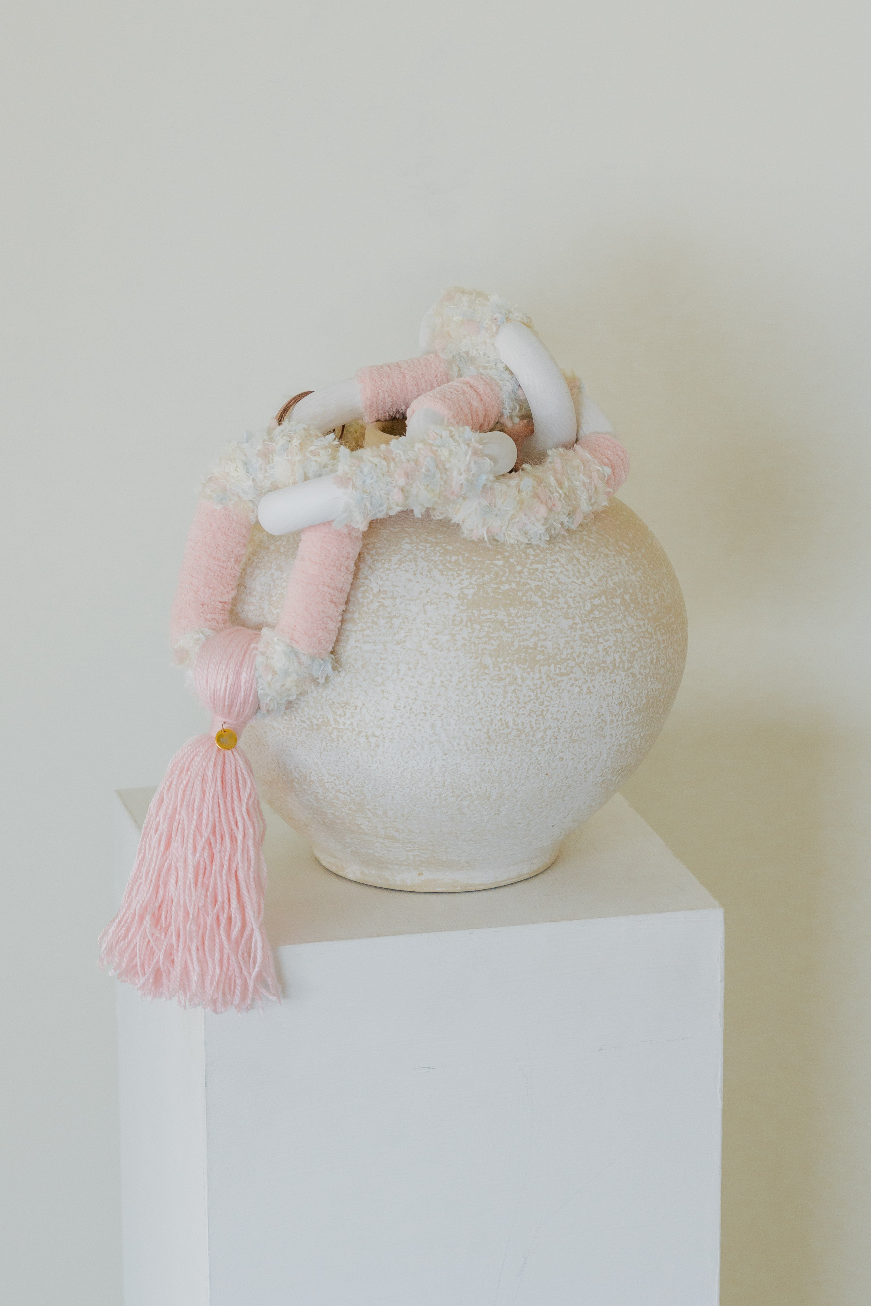 Passing By Blooms Rose fibre wall art — soft rose-pink and cream yarn woven with leather, evoking a gentle field of blooming petals.