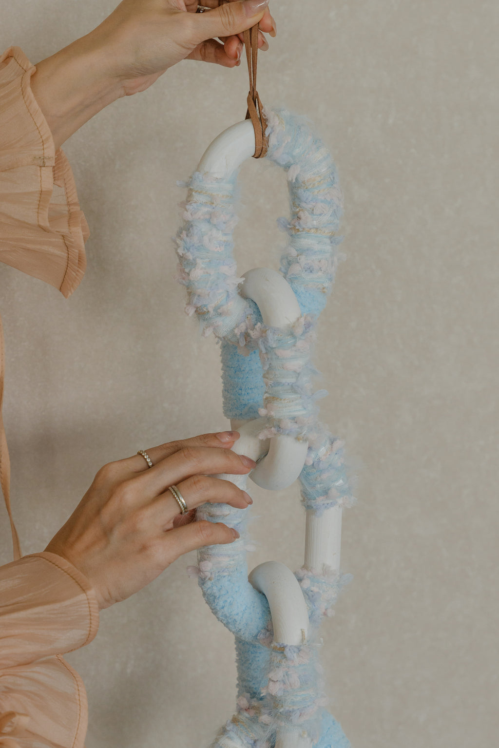 Handmade ‘Passing By Blooms Delphinium’: subtly layered threads in soft blue and purple shades, interlaced with leather to capture a field of gentle delphinium flowers.