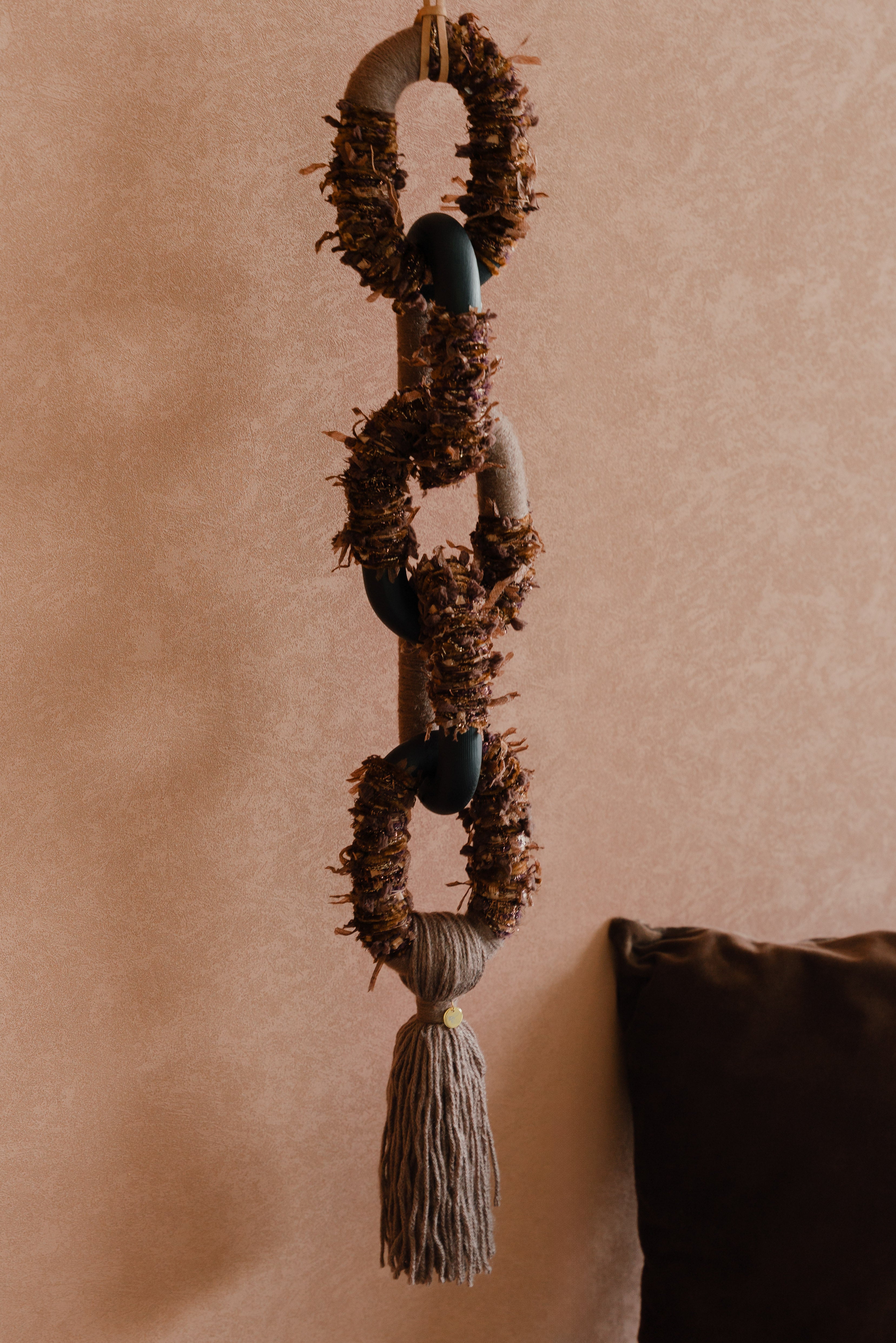 Bespoke textile art ‘Passing By Blooms Mocha’: woven yarn in soft brown and ivory shades, interlaced with leather trimmings for a delicate floral impression.