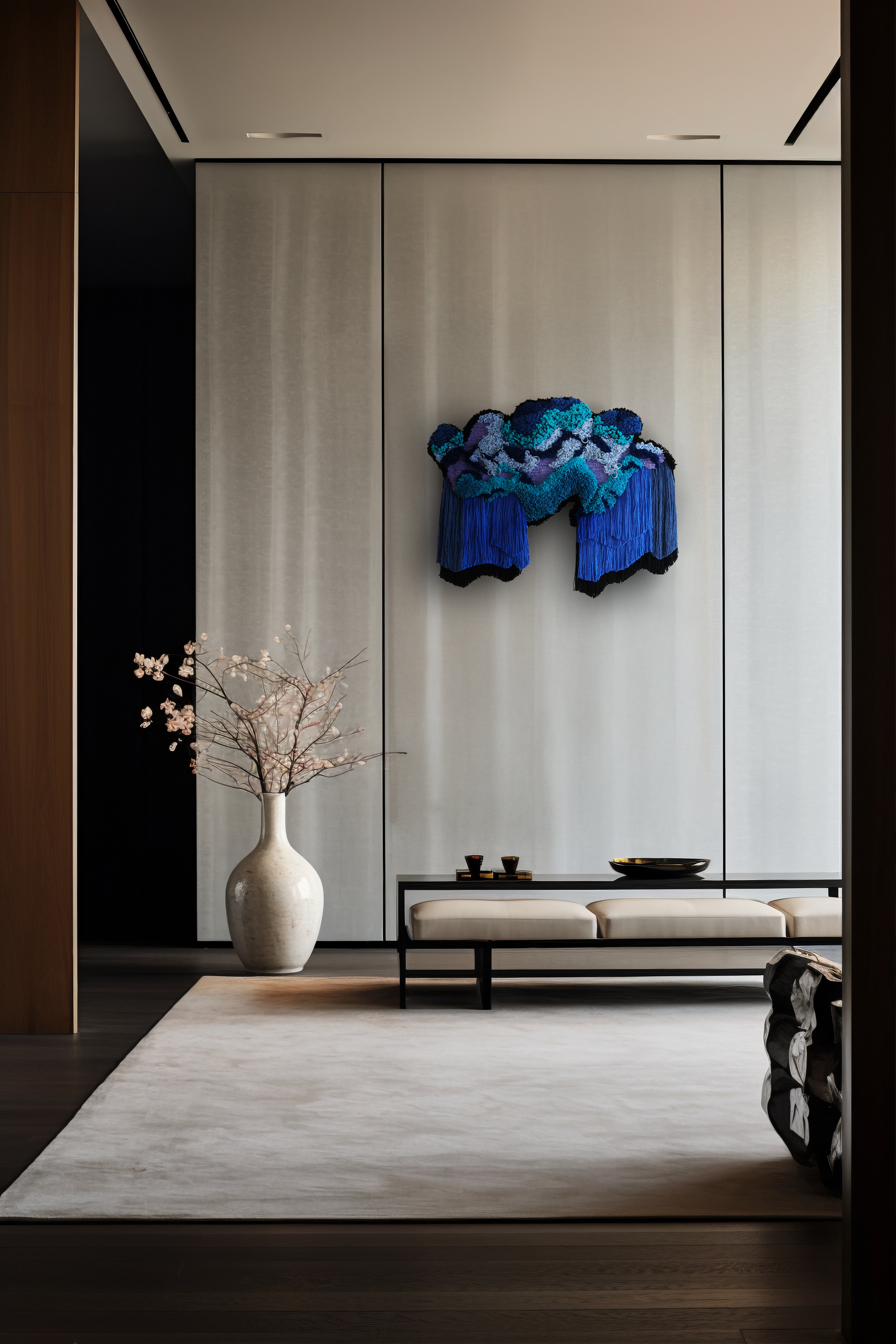 Cascade’ fibre wall art: layers of blue and purple yarn flow like a misty waterfall, accented with hand-stitched leather for texture and depth.