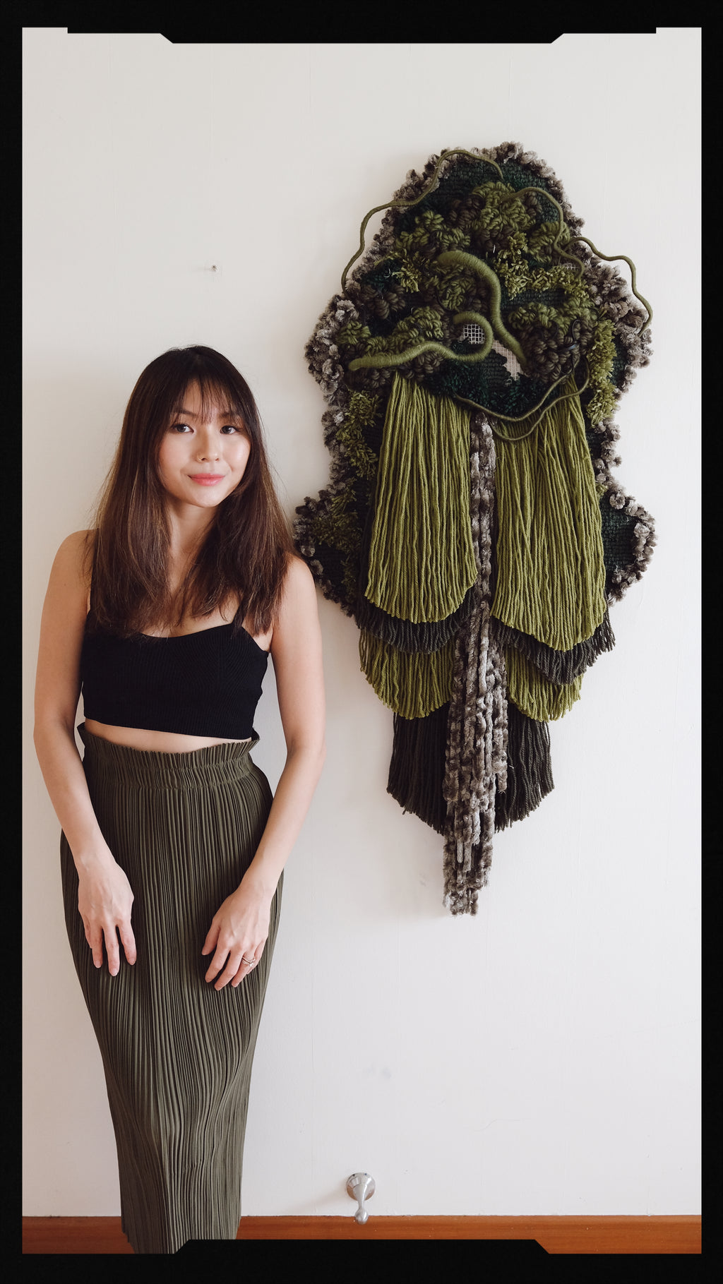 Bespoke fibre wall art ‘Repose’ — layered green yarn and repurposed leather woven into a tranquil pine forest scene