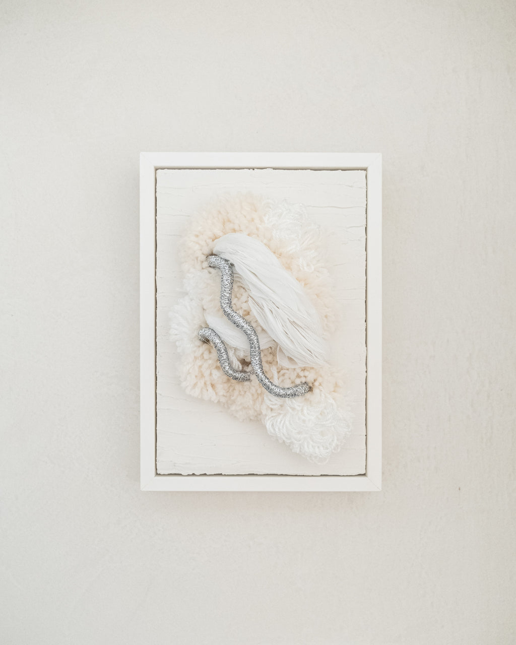 Cocoon N°4 fibre wall hanging — soft neutral yarn in cream and taupe woven into a cocoon-like sculptural form.