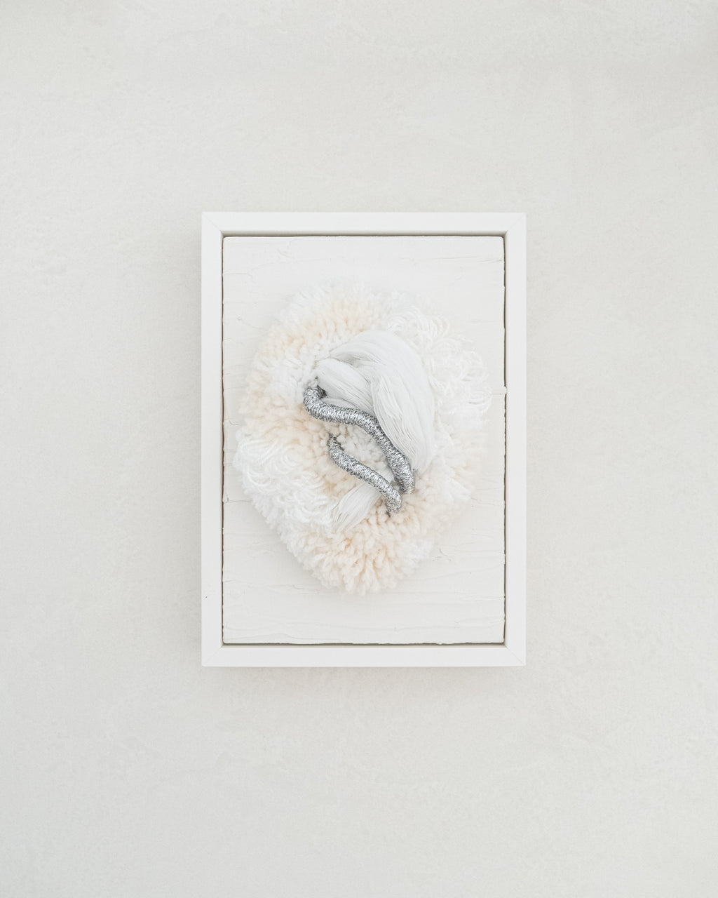 Cocoon N°2 fibre wall art — neutral cream and beige yarn sculpted into a soft, cocoon-like form with gentle curves.