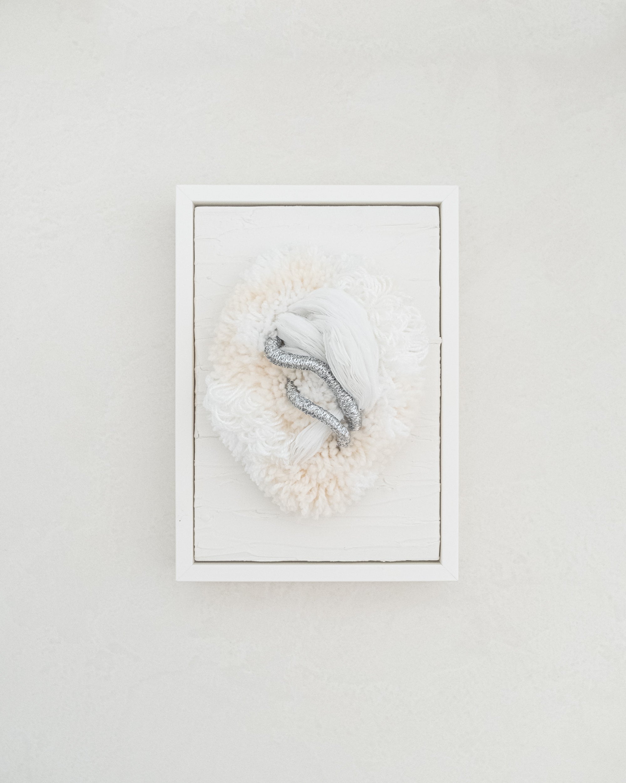 Cocoon N°2 fibre wall art — neutral cream and beige yarn sculpted into a soft, cocoon-like form with gentle curves.