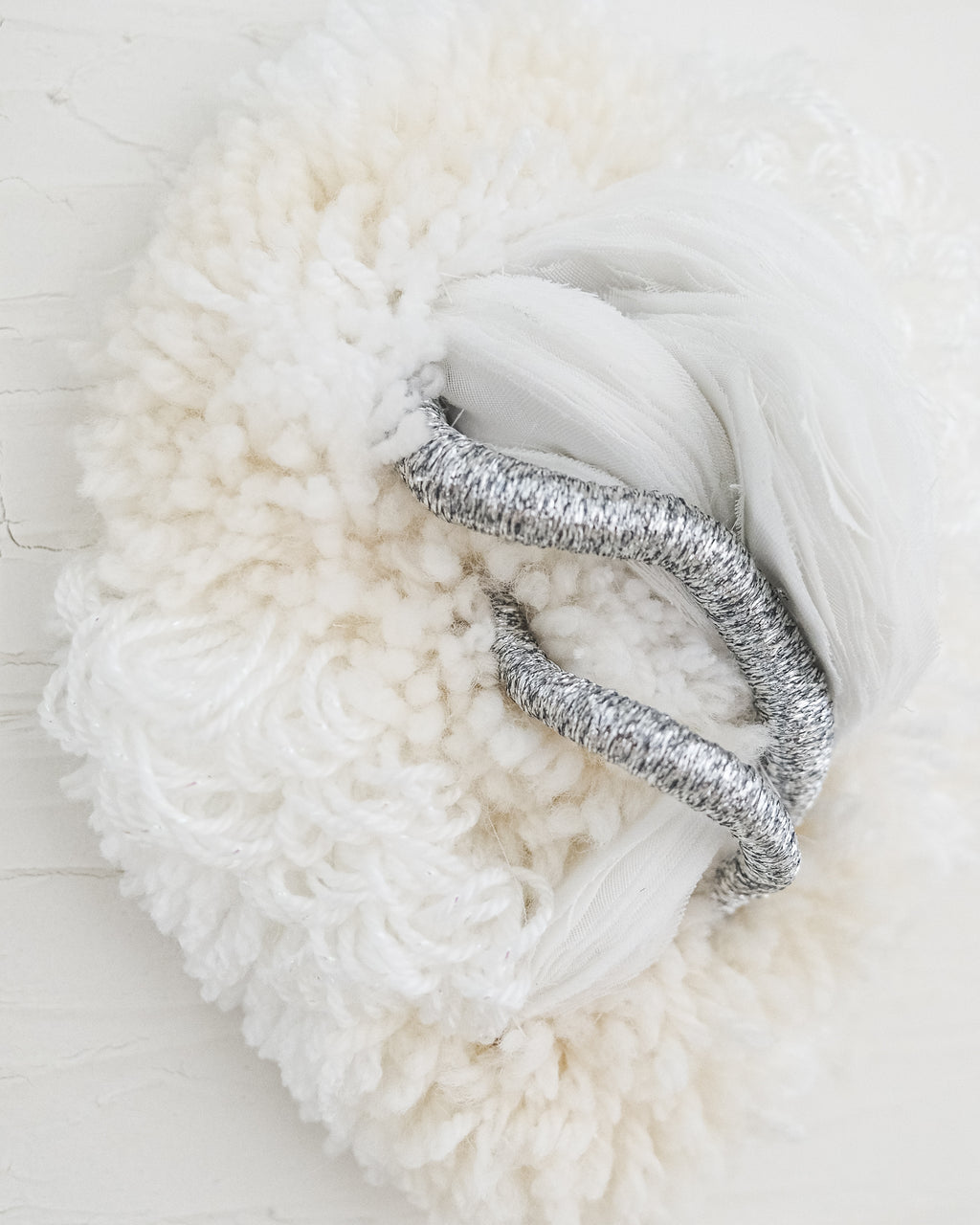 Close-up of Cocoon N°2: layered natural fibers in soft beige, showing the tactile, handcrafted weave.