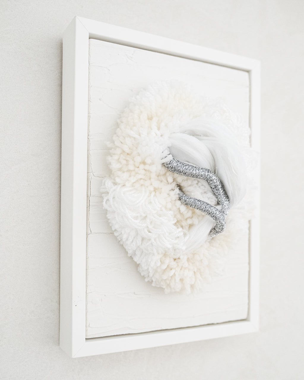 Lifestyle image of Cocoon N°2 hanging above a console, its neutral palette and soft textures blending harmoniously with minimalist décor.