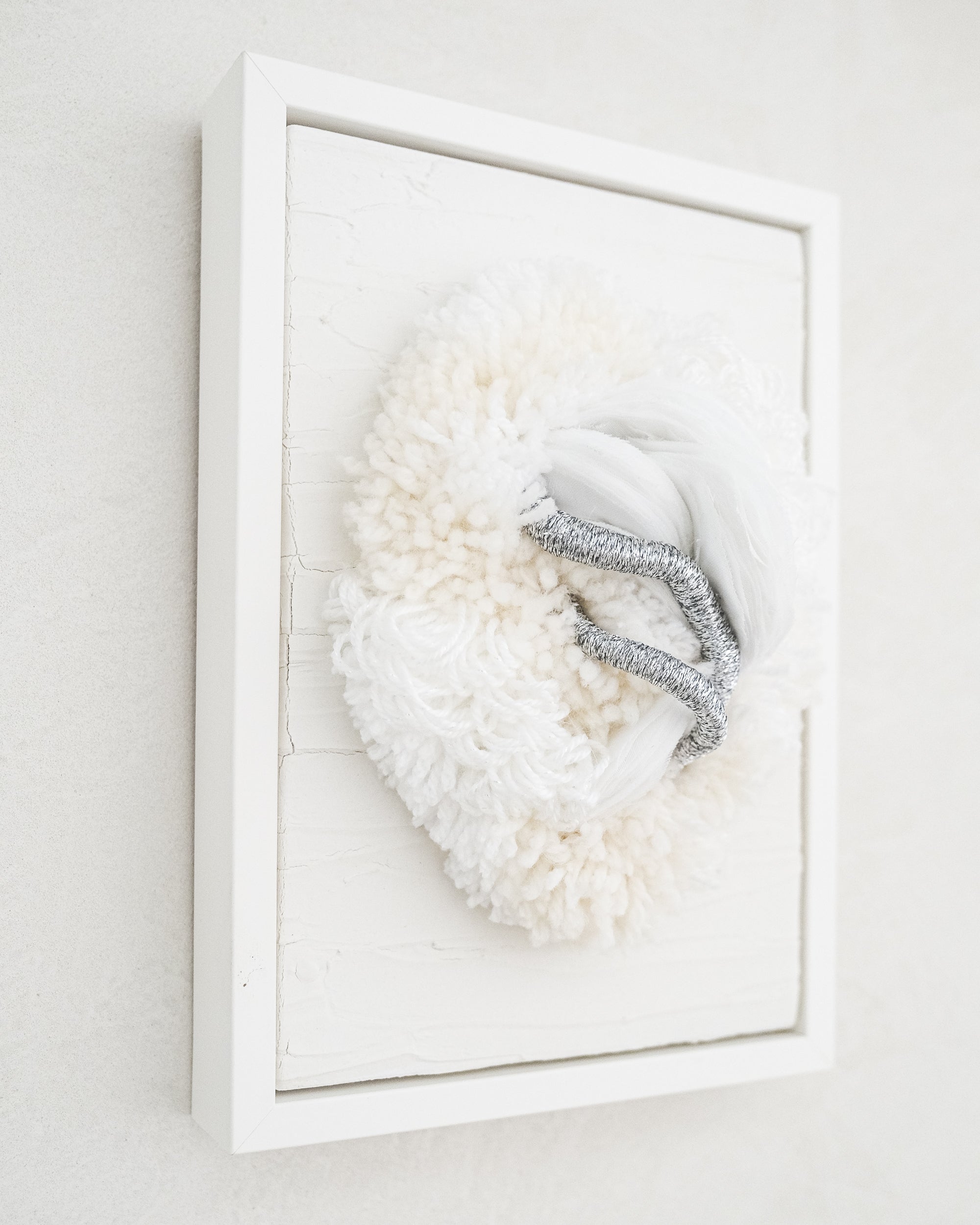 Lifestyle image of Cocoon N°2 hanging above a console, its neutral palette and soft textures blending harmoniously with minimalist décor.