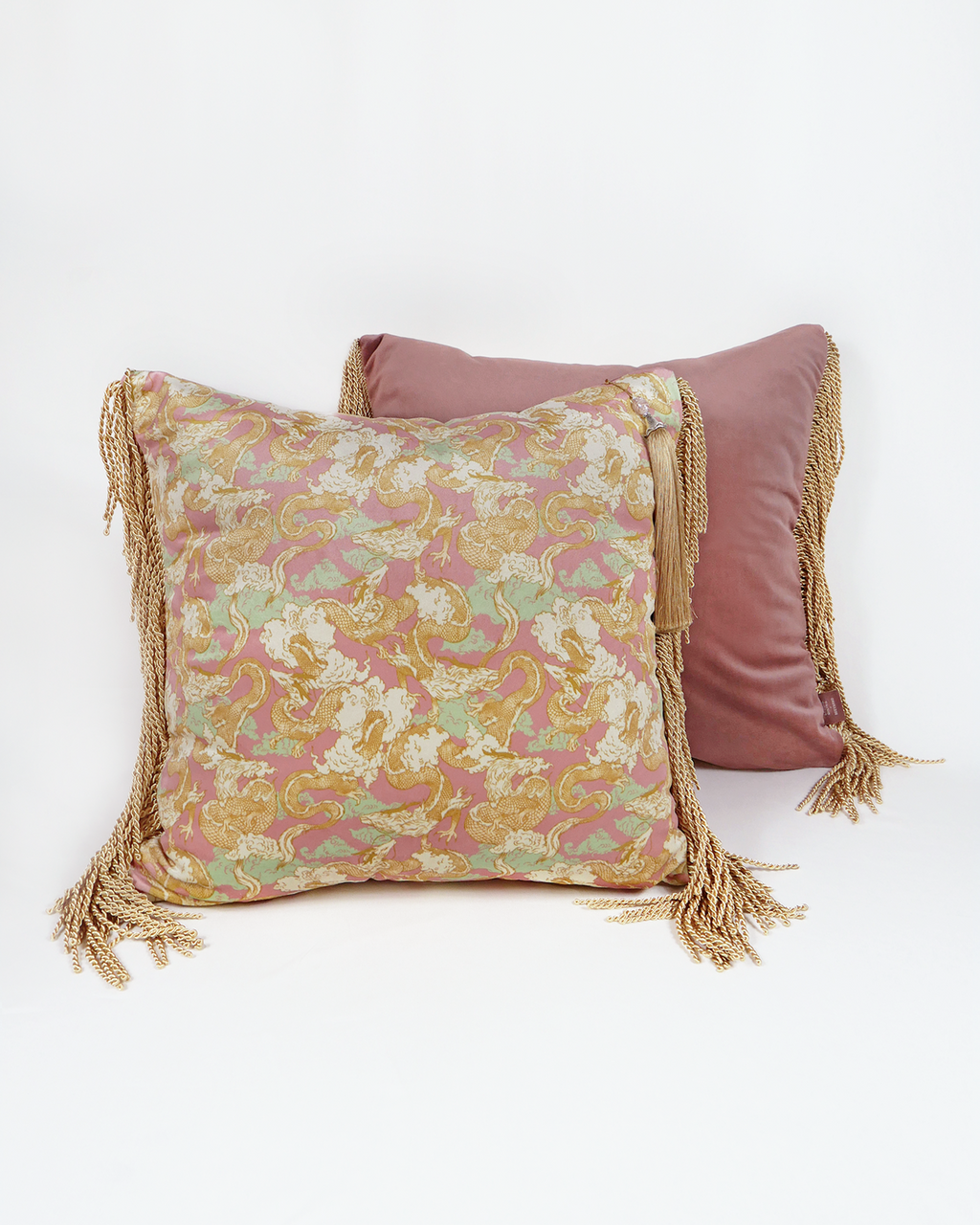 Close-up of Dragon Dreams cushion: detailed dragon embroidery in gold thread against deep teal fabric.