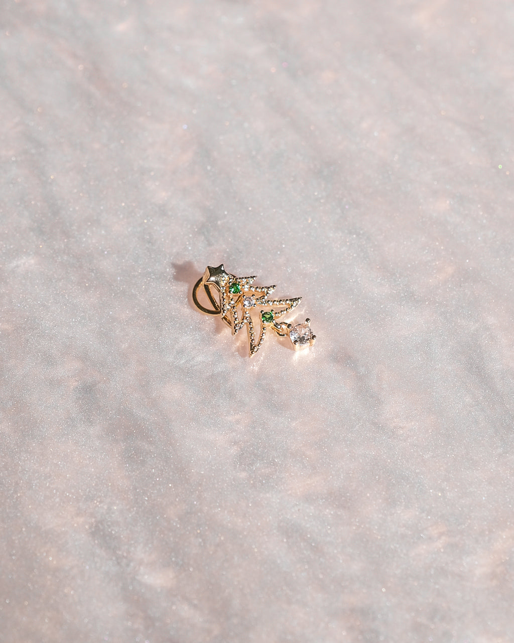 Limited edition holiday bag charm with gold detailing and artisan design.