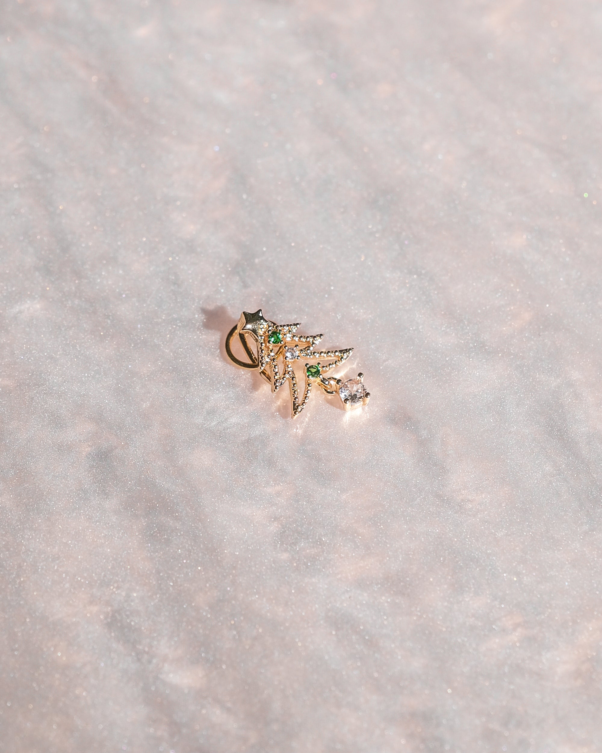 Limited edition holiday bag charm with gold detailing and artisan design.