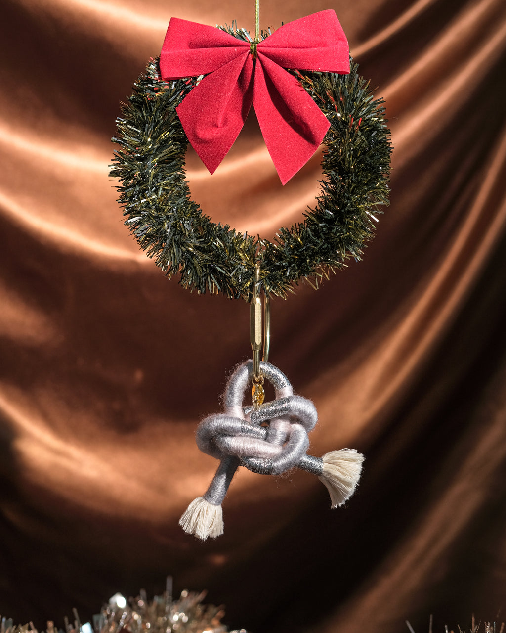Limited edition Silver Cloud bag charm on festive backdrop.