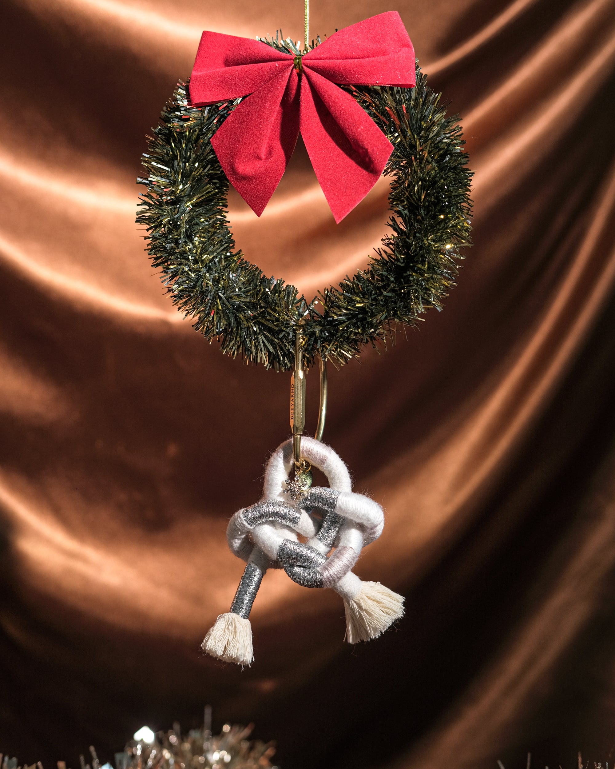 Handmade Snow Angel Ethereal bag charm detail – pendant, knot, and tassels against festive backdrop.