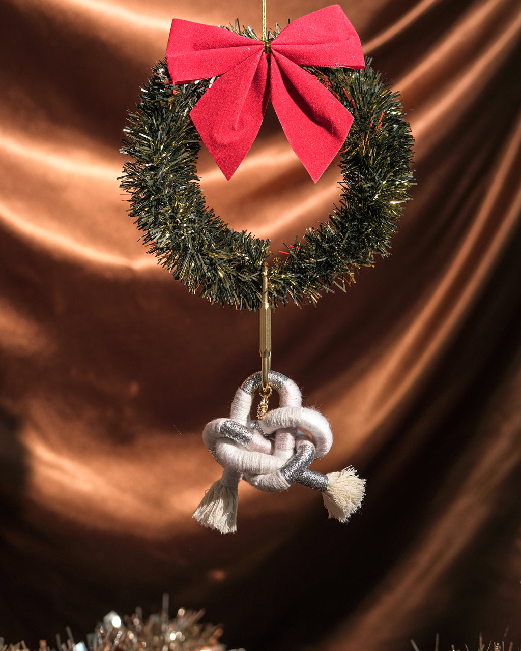 Close-up of Snow Angel Ethereal bag charm showing snowflake pendant and fine handmade knot detail.