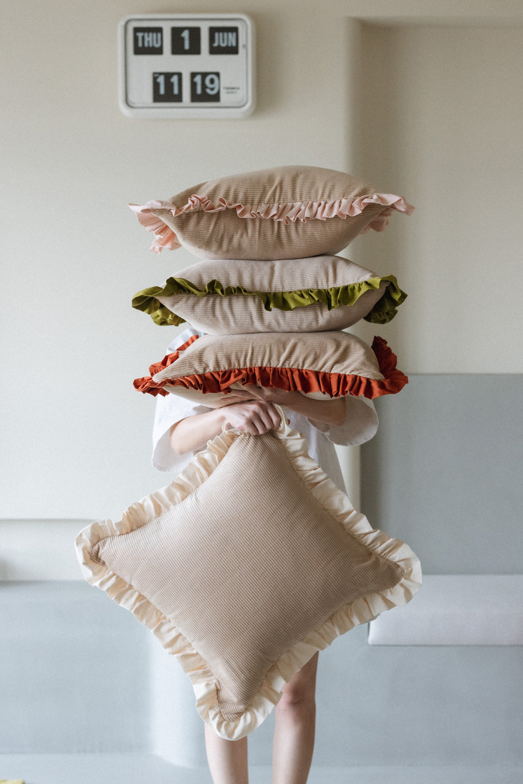 Warm Hugs Rust Cushion adding warmth and style to bedroom or lounge area.