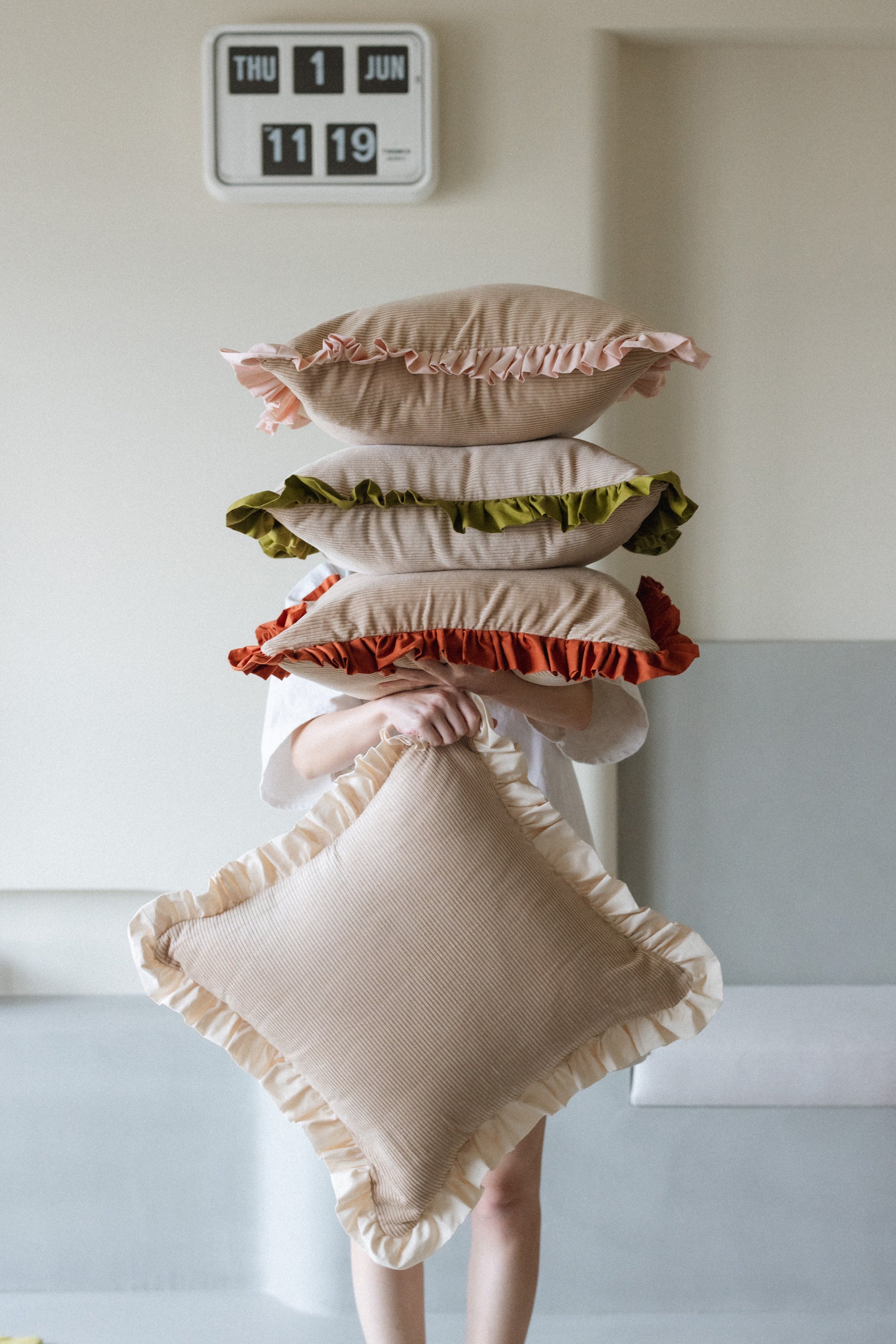 Warm Hugs Rust Cushion adding warmth and style to bedroom or lounge area.