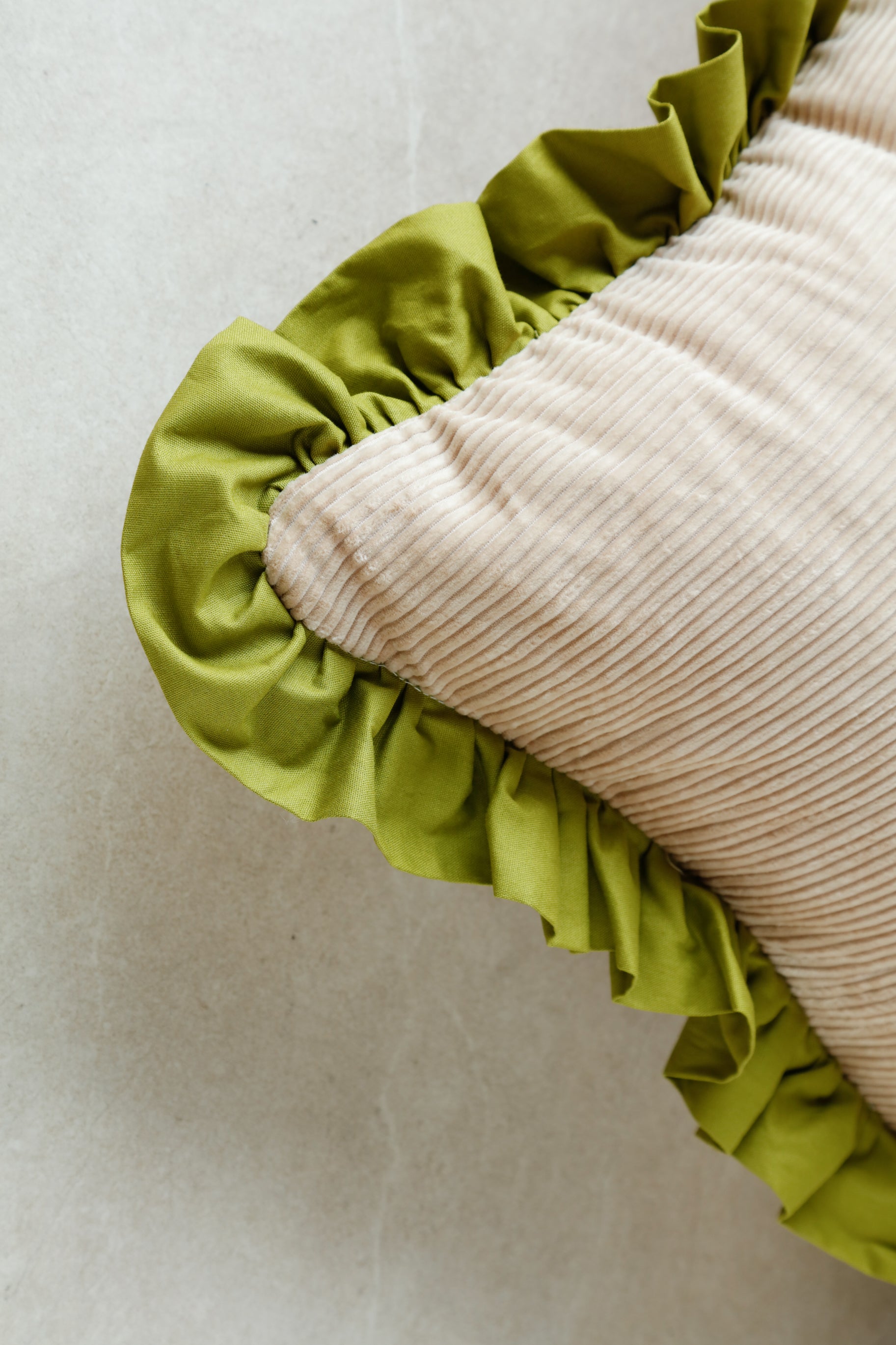 Close-up of chartreuse velvet finish on BeeYarnd Good Vibes cushion showing fabric pile and stitching detail.