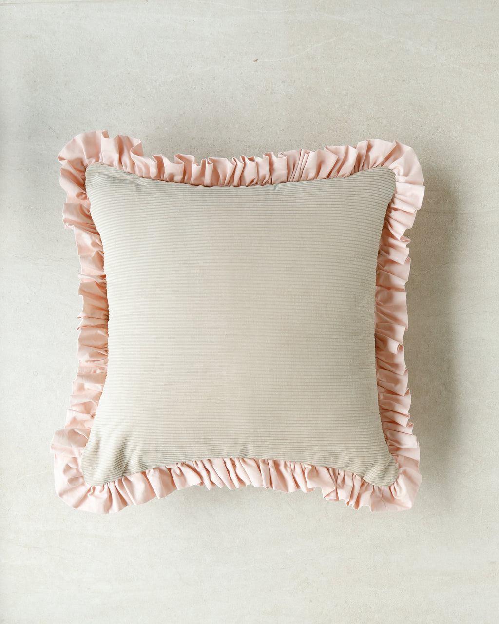 Minimalist product shot — Kind Words Rosewater Cushion isolated on white background.