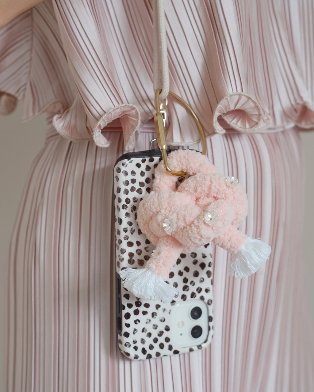 Flamingo Ethereal keychain accessory attached to a handbag, featuring a graceful pink flamingo and gold hardware.