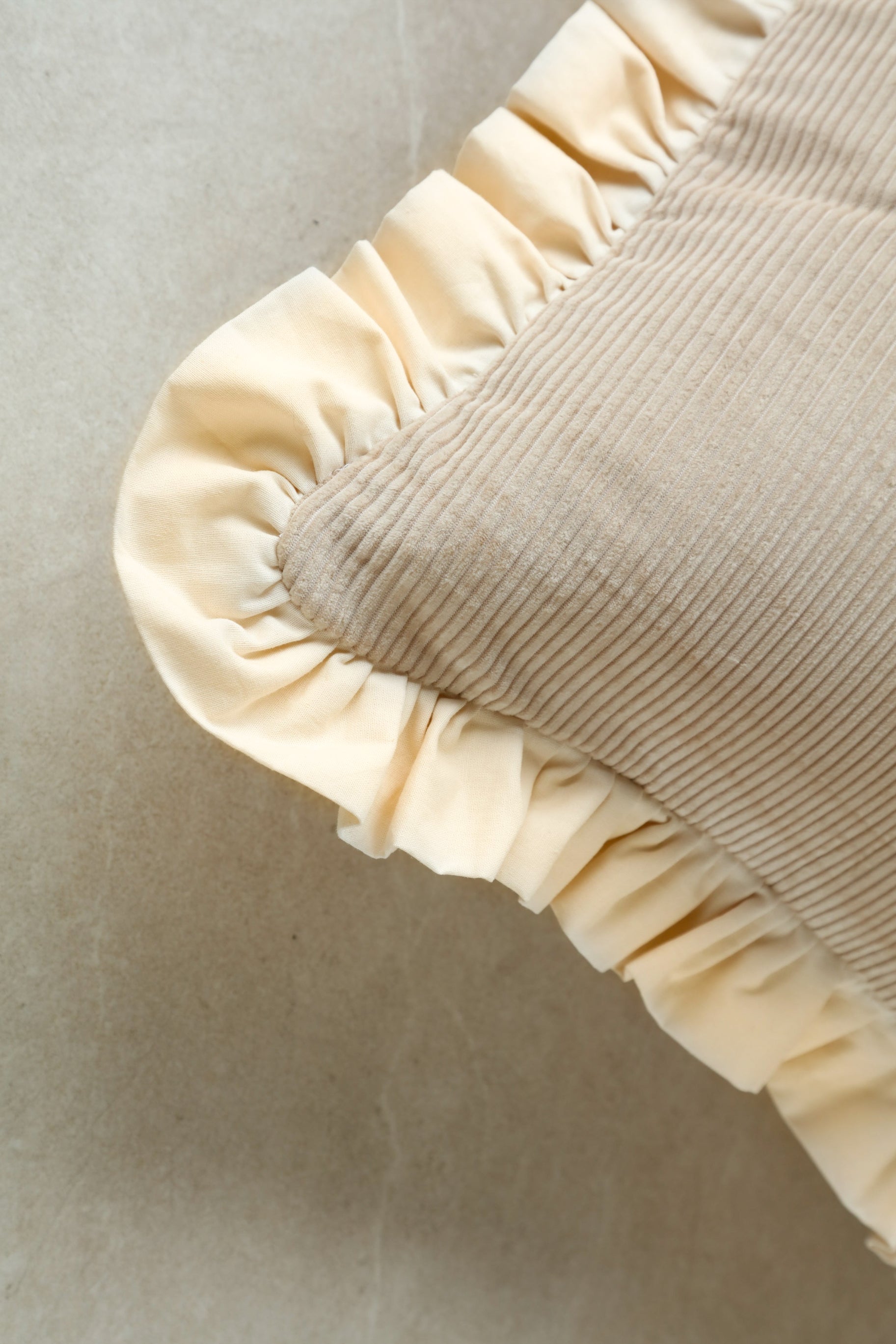 Close-up of Gentle Touch cushion showing corduroy texture and plush finish.