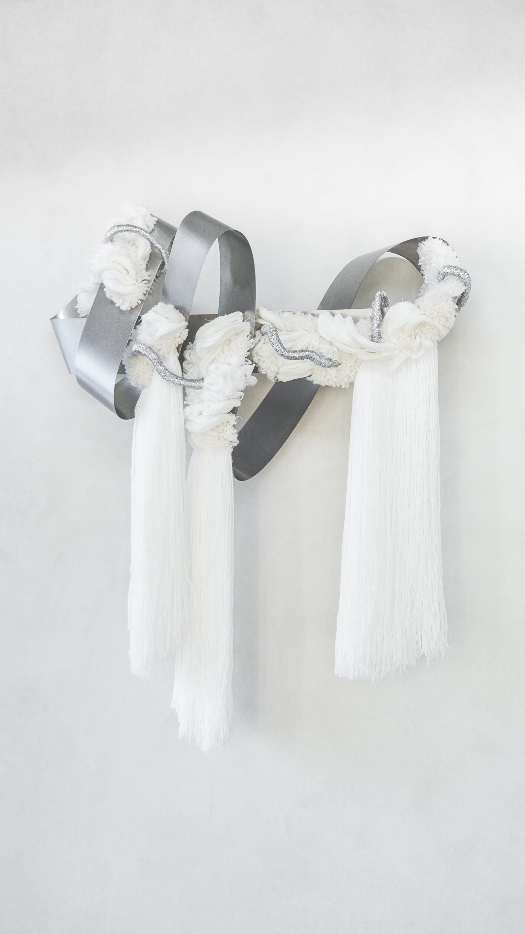 The Morning Glow fibre wall sculpture — soft golden yarn woven into a radiant, sunlit cocoon‑like form.